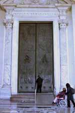 An attendant opens the door with wheelchair ramp to the basilica